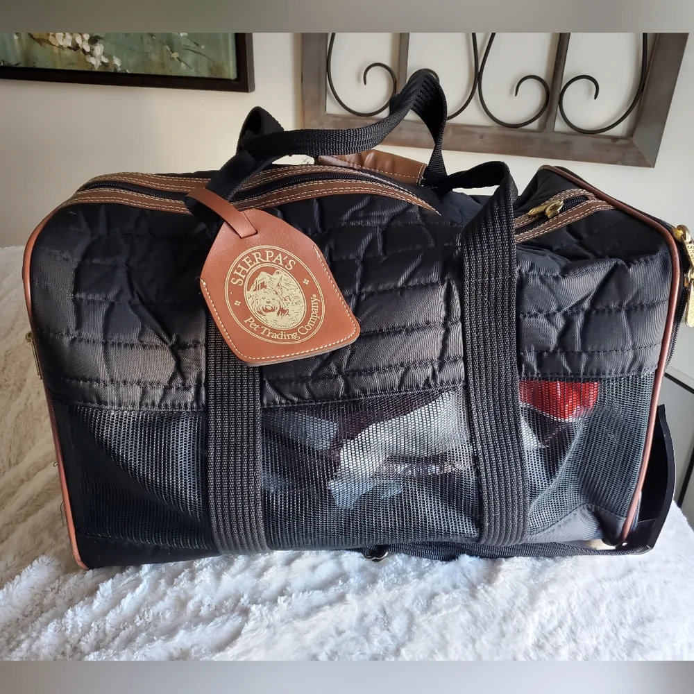 SHERPA'S mid size pet carrier with handles and shoulder strap.